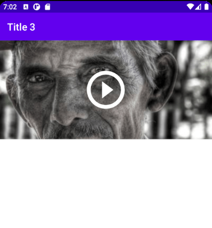 Pantalla de detalle con TopAppBar Title 3 y la foto del item con el icono de vídeo debajo